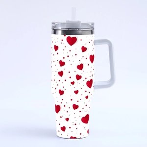 Detailed view of 40oz tumbler with red hearts and dots pattern, handle and clear straw