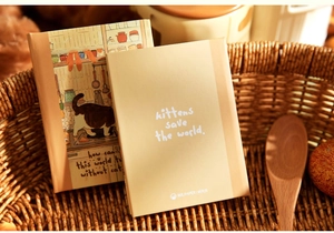Detailed view of Mr. Paper A7 notebook featuring cute kittens save the world illustration