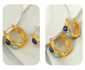 Detail of C-shaped gold-plated earrings featuring blue and green natural gemstones