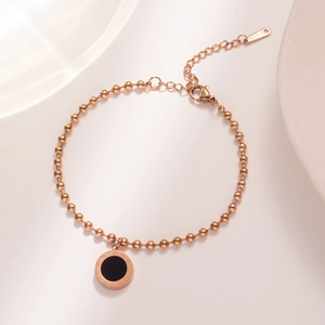 Rose gold stainless steel bead bracelet featuring a black Roman numeral charm