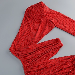 Detailed view of red rhinestones and premium fabric texture on the evening gown