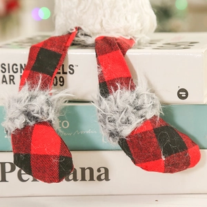 Detail of red and black buffalo plaid gnome legs with fluffy grey faux fur trim decor