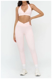 Close-up of pink yoga set with V-cross high waist leggings and functional side pockets