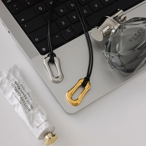 Minimalist 18K gold and silver irregular O-ring pendants on black wax cords for women