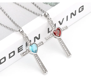 Detail showing cross heart pendants with sky blue and deep red zircon stones