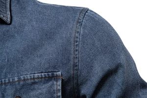 Macro detail of high-density blue denim shirt with durable double-stitched shoulder seams