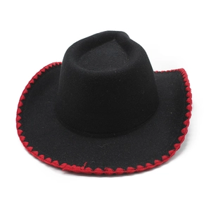 Close-up of black western cowboy hat featuring red contrast edge stitching and felt texture