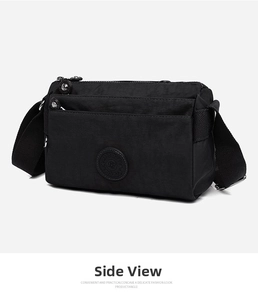 Detail view of multi-pocket nylon crossbody bag featuring smooth zippers and a round logo