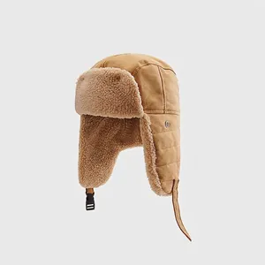 Detail view of khaki trapper hat featuring warm faux shearling lining and ear flaps