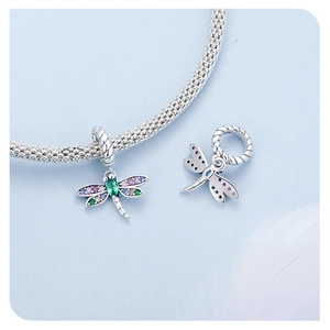 Detail of S925 sterling silver dragonfly charm with colorful zircon stones on bracelet
