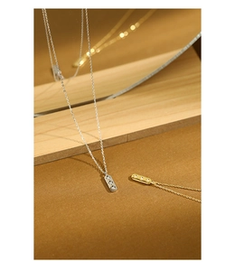 Close-up of geometric rectangle bar pendant with three sparkling cubic zirconia stones