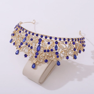 Detailed view of luxury baroque golden crown with blue crystals and intricate rhinestones