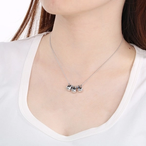 Polished silver teardrop pendant necklace worn by model showing elegant neck drape