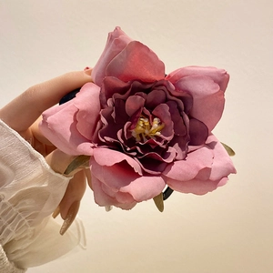 Elegant fabric orchid hair claw clip in pink with detailed petals and yellow stamen