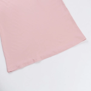Close-up of pink dress hem showcasing double-needle stitching and fabric texture