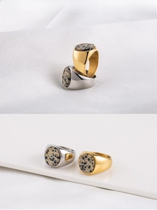 Detail of 18K gold plated and silver steel rings with natural speckled stone inlays