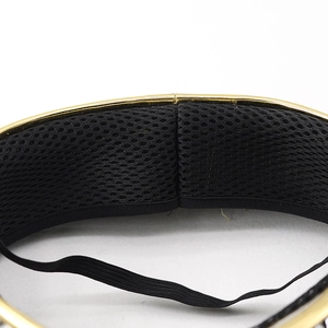 Detail of breathable honeycomb mesh lining and golden trim on a festive masquerade mask