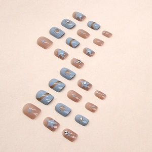 Short blue star press-on nails with gold foil and rhinestones in Morandi blue design