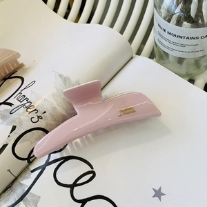 Pink jelly acetate hair claw clip with golden French lettering for elegant updos