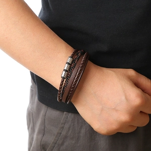 Men's multilayered bracelet featuring brown and black braided leather with silver beads