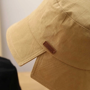 Women's UV protection bucket hat in khaki cotton with stylish leather patch detail