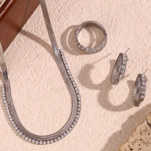 Detail of silver fishbone pattern necklace and ring set with cubic zirconia stones
