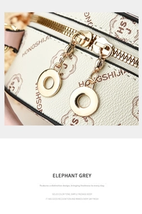 Detail of elephant grey lychee textured leather bag with gold hardware and zipper