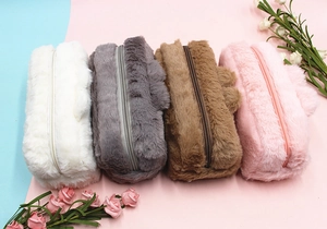 Close-up of soft plush pencil cases with metal zippers in four different colors