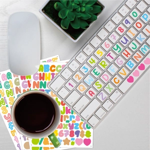 Macro shot of colorful alphabet and number stickers on a laptop keyboard in home office setup