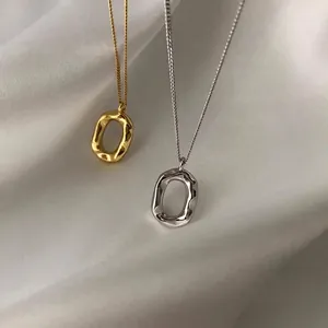 S925 sterling silver oval donut necklaces in gold and silver on white silk
