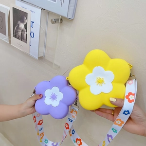 Detailed view of kids camellia silicone crossbody bags in yellow and purple with floral straps