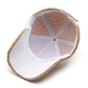 Inside view of brown fuzzy plush baseball cap with white lining and reinforced stitching