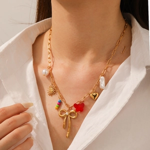 Golden stainless steel necklace with butterfly bow, pearls and multi-element charms