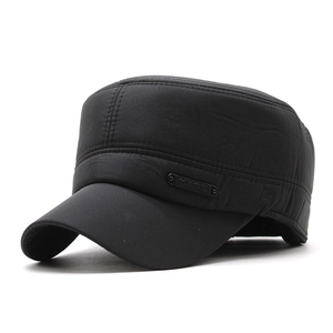Detail of black cadet cap featuring side stitching and metallic oval logo plaque