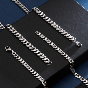 Mens silver stainless steel cuban link chain necklace on a black geometric stand