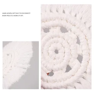 Handmade cream macrame coaster with fringe detail and durable woven spiral pattern