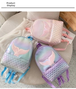 Detailed view of three mermaid backpacks with shiny laser scales and 3D fin decoration