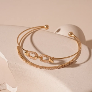 Double-layered golden open cuff bracelet with zircon accents and link pattern