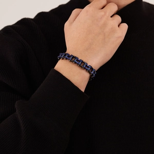 Men's punk stainless steel bike chain bracelet in black and blue on a model's wrist