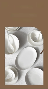 White porcelain tableware set with embossed floral patterns and elegant relief details