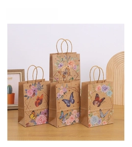 Macro detail of kraft paper gift bags with elegant butterfly and floral printing