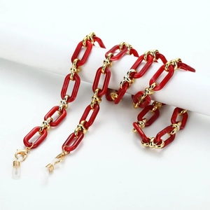 Close-up of red resin chain links with gold metal connectors and silicone loops