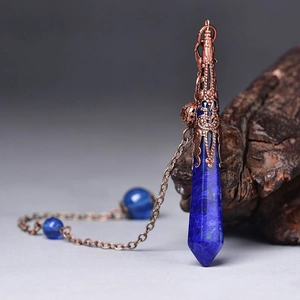 Macro shot of blue hexagonal stone pendant with vintage copper cap on rustic wood
