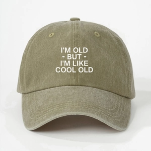 Detailed close-up of distressed olive green cotton twill baseball cap fabric and printed text