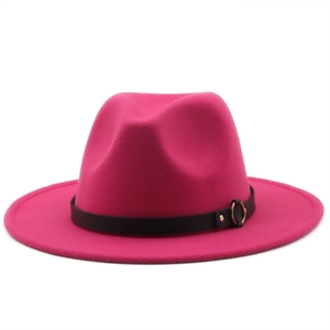 Close-up of rose red wool felt fedora hat with black leather band and gold metal buckle