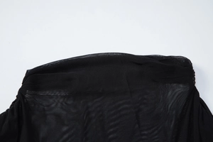 Detail shot of the sheer black mesh fabric and high-quality stitching on the dress