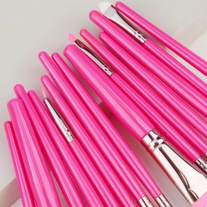 Detailed view of pink synthetic fiber bristles on a 15-piece professional makeup brush set