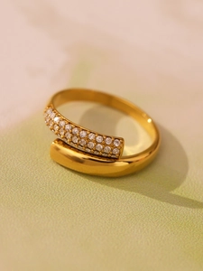 Macro detail of 18K gold plated ring featuring sparkling pavé cubic zirconia settings