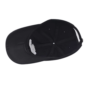 Detail of black cotton baseball cap interior featuring white embroidery patch and stitching