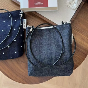 Vintage denim canvas crossbody phone bags with stripe pattern on a wooden table